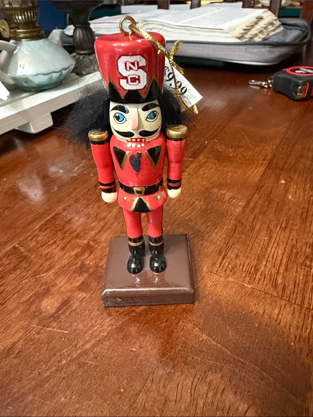 Red Nutcracker Holiday Ornament with Black Hair represents NC State